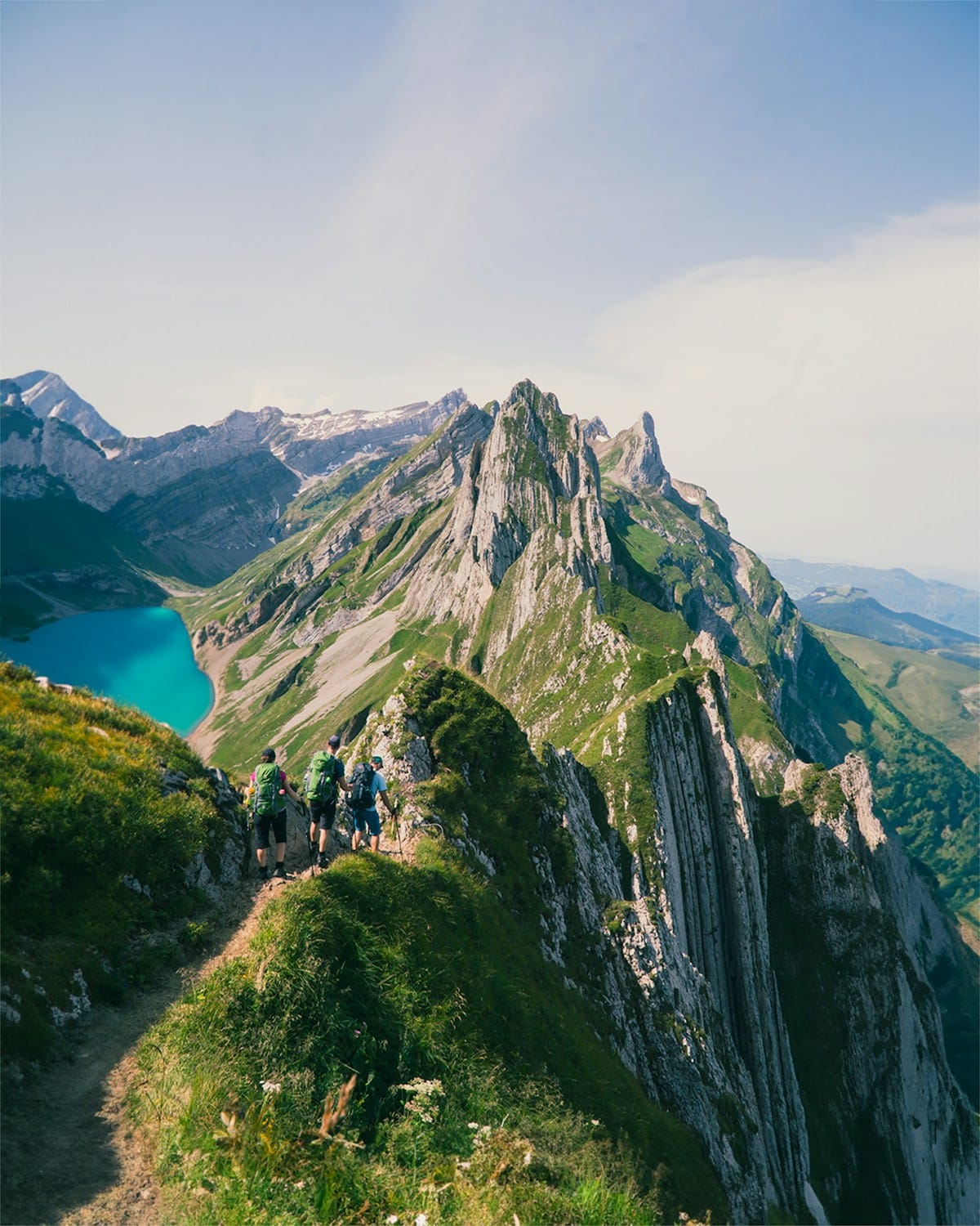 Breathtaking Swiss Alps hiking trail with professional guides leading curated mountain adventure experience